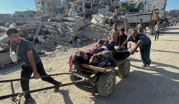 Palestinians assisting casualties following an Israeli airstrike in Beit Lahia, northern Gaza Strip, on Wednesday.